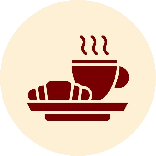 Breakfast icon with steaming coffee and croissant on plate